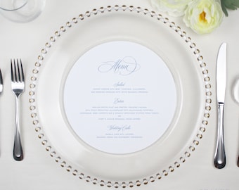 May include: A white menu card with a gold rimmed plate and silverware. The menu includes a salad, entree, and wedding cake. The text on the menu card reads "Menu", "Salad", "Entree", "Wedding Cake", and "SEALED".