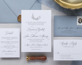 May include: Wedding invitation suite with a blue envelope, a white invitation card with a floral design, a white RSVP card, and a white details card. The invitation card features the text "Emerson Elizabeth to Jan Thomas Murray" and the date "Saturday, the Twentieth of May Two Thousand Twenty-Three".