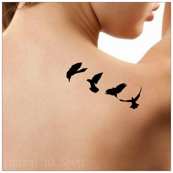 birds in flight silhouette tattoo