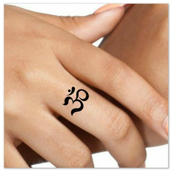 Om tattoo on the wrist.