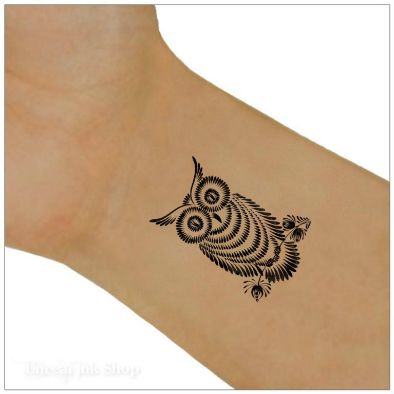 tribal owl arm tattoos