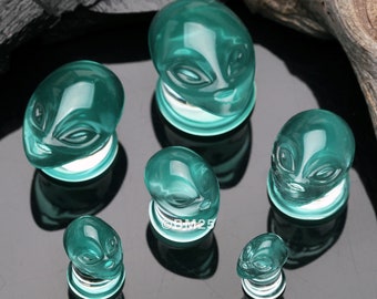 A Pair Of Green Alien Head Glass Double Flare Plugs