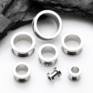 A Pair of Implant Grade Titanium Screw-Fit Tunnel Plug