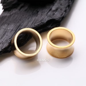 A Pair of Golden Solid Steel Double Flared Ear Gauge Tunnel Plug