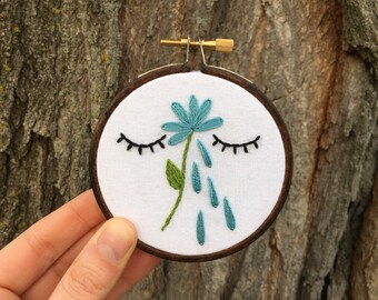 Embroidery Magnet - eyes closed, blue flower tear drops, hand stitched 3" embroidery hoop