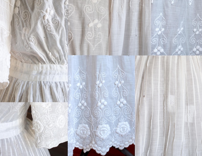 May include: Close-up of a white dress with intricate embroidered details. The dress features floral and scrollwork patterns, with a scalloped hemline. The fabric appears to be lightweight and textured, with vertical pleats and detailed sleeves.