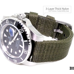 May include: A black and silver Rolex Submariner watch with a green 3-layer thick nylon watch strap. The strap is 3mm thick and is made of durable military grade nylon.