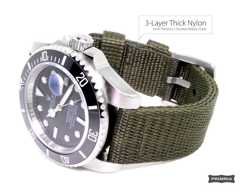 May include: A black and silver Rolex Submariner watch with a green 3-layer thick nylon watch strap. The strap is 3mm thick and is made of durable military grade nylon.