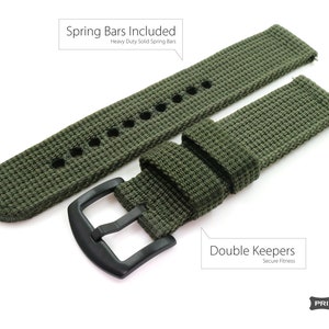 May include: A green nylon watch strap with black hardware. The strap has double keepers and includes spring bars. The strap is labeled "Spring Bars Included" and "Double Keepers".