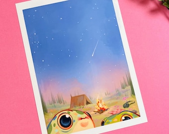 May include: A whimsical art print featuring a camping scene under a starry sky. Two cartoon-like creatures with large eyes peek from the bottom. A campfire, tent, and trees are visible. The print is on a white background with a pink backdrop.