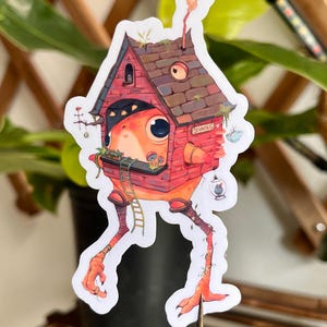 May include: A whimsical sticker featuring a house-like creature with a red brick facade, a brown shingled roof, and long orange legs. The creature has a large eye, a ladder, and the word "CURE" on a small sign.