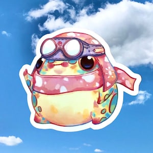 May include: A colorful cartoon frog wearing a pink and white scarf and goggles. The frog is looking up at the sky.