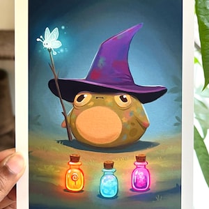 May include: A cartoon frog wearing a purple and pink wizard hat holds a stick with a glowing butterfly at the top. The frog is sitting in front of three small glass bottles with colorful glowing liquids inside.
