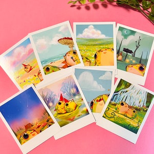 May include: Set of eight illustrated postcards featuring cartoon frogs in various settings. The postcards are printed on white cardstock with a white border. The frogs are depicted in a variety of poses and expressions, including smiling, sleeping, and playing. The postcards are perfect for sending a whimsical message to a friend or loved one.