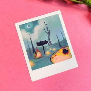 May include: A whimsical illustration of two frog-like creatures in a forest setting. One frog is wearing a pointed hat and the other is looking up at a sign that reads "CANDY". The background is a blue-green color with a crescent moon in the sky.