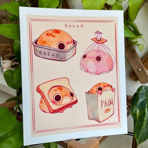 May include: A whimsical art print featuring four different types of bread with cute, cartoonish faces. The print includes a loaf in a pan, a blob in a bag, a slice of toast, and a loaf in a paper bag labeled "PAIN". The word "bread" is written at the top.