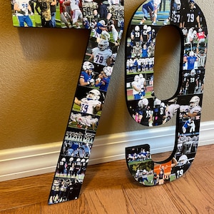 May include: A large wooden number 79, decorated with a collage of football action photos. The photos feature players in blue and white uniforms. The numbers are displayed on a wooden floor.