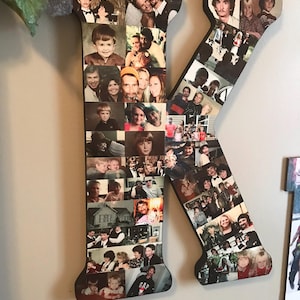 May include: Wooden letter "K" with a collage of family photos. The letter is black with a red border and features a variety of images. The top of the letter has the text "Kurt Lee Malawy - 3/29/1969-3/25/2018".