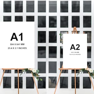 May include: Two white poster boards on easels with black text indicating the paper sizes A1 and A2. The A1 poster board measures 23.4 x 3.1 inches and the A2 poster board measures 16.5 x 23.4 inches. Both easels are decorated with white flowers.