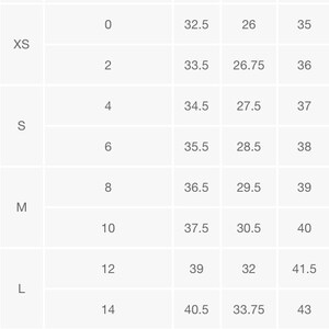 May include: A white clothing size chart with grey headers labeled Size, Numeric Size, Bust, Waist, and Hip. The table lists sizes from XXS to XXL with corresponding numeric values and body measurements in inches for each category.