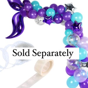 May include: A purple and blue balloon garland with a purple foil mermaid tail. The garland is decorated with silver and purple stars. The text "Sold Separately" is visible in the image.