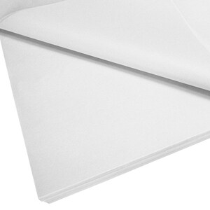 May include: A stack of white tissue paper. The paper is folded in half and the edges are visible.