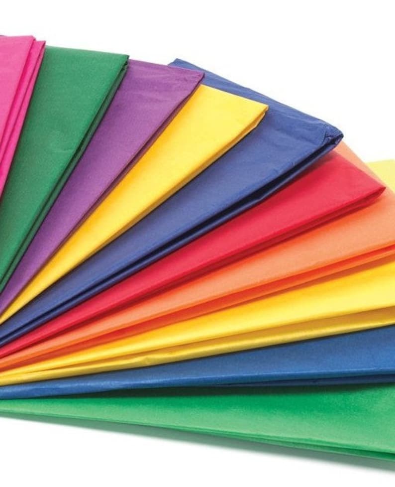 May include: A stack of colorful tissue paper in various shades of pink, green, purple, yellow, blue, red, orange, and light yellow. The tissue paper is folded in a fan shape.