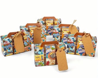 May include: Set of six small cardboard boxes shaped like suitcases with a vintage travel theme. The boxes are decorated with colorful travel stickers and have brown paper tags attached.