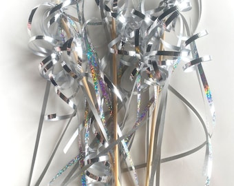 May include: A bunch of silver and iridescent streamer wands with wooden sticks. The streamers are curled and twisted.