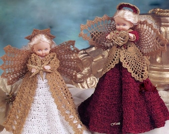 May include: Two angel dolls with blonde hair and crocheted outfits. One doll wears a white dress with a gold overlay and holds a star, labeled Charity. The other wears a deep red dress with a gold overlay and halo, holding a heart, labeled Faith.