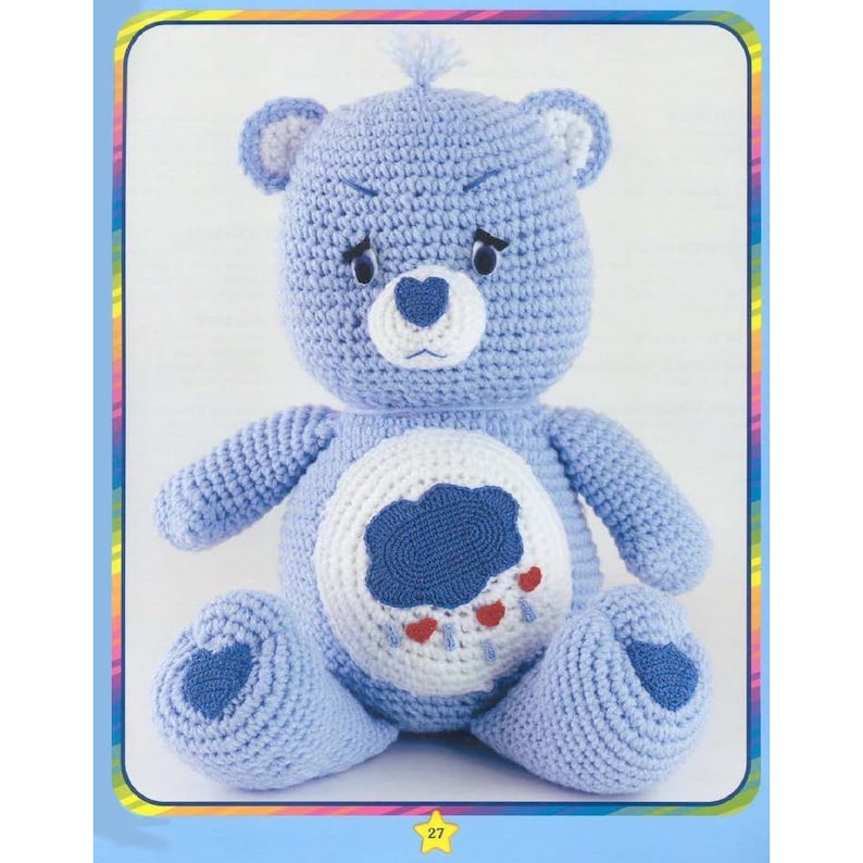 May include: A crocheted blue Care Bear with a white belly and a blue cloud with red raindrops on it. The bear has a heart-shaped nose and a grumpy expression.