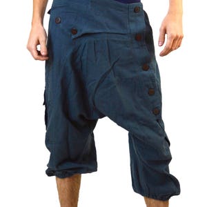 May include: A pair of dark blue, knee-length, loose-fitting trousers with a button fastening and a unique design.