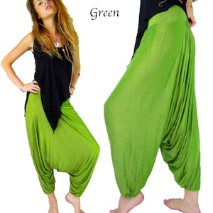 May include: Green harem pants with a loose, flowing fit. The pants are made of a soft, comfortable fabric and have a wide, elastic waistband.