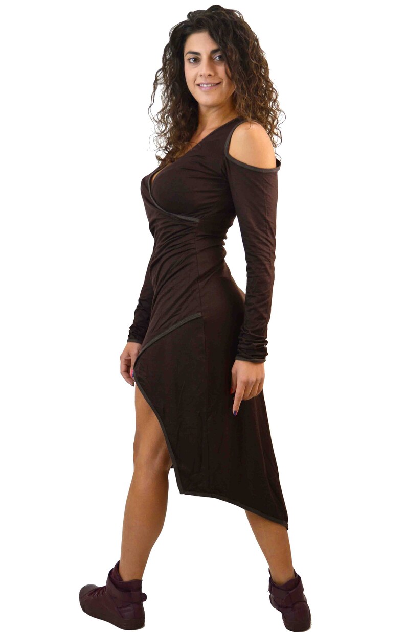 May include: A dark brown dress with long sleeves and a wrap-style bodice. The dress features a high-low hemline and cut-out shoulder details. The person is wearing dark burgundy high-top sneakers.