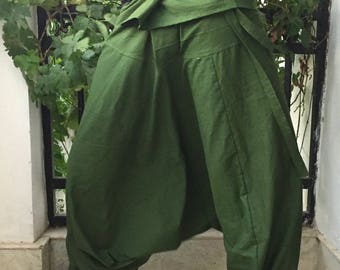 May include: A pair of green, loose-fitting pants with a wide waistband and a gathered design. The pants are made of a soft, comfortable fabric and have a relaxed fit.