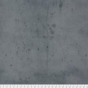 May include: A close-up of a gray fabric with a textured, mottled appearance. The fabric has a distressed look with dark spots and subtle variations in tone. A ruler is at the bottom of the image, with markings in inches.