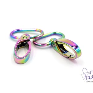 May include: Two iridescent rainbow-colored metal swivel clasps. The clasps are oval-shaped with a spring-loaded gate.