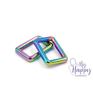 May include: Two iridescent rainbow-colored metal D-rings. The rings are rectangular in shape and have a smooth, polished finish.
