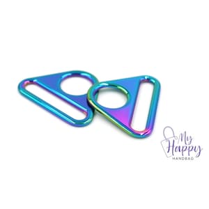 May include: Two iridescent rainbow-colored metal triangle-shaped D-rings with a circular opening in the center.