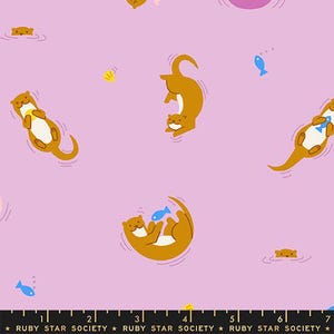 May include: A repeating pattern on a light purple background features cartoon otters in various poses, some holding blue fish. The otters are brown with white bellies. Small yellow and blue accents are scattered throughout the design. The text "RUBY STAR SOCIETY" is at the bottom.