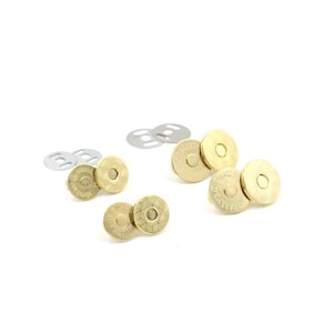 May include: Four sets of gold magnetic snap closures. Each set includes two round pieces with a decorative pattern. The snaps are ideal for sewing onto clothing or crafts.