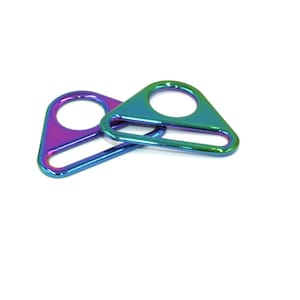 May include: Two iridescent triangle-shaped metal slider buckles with a single hole and a flat bar. The buckles are a mix of blue, green, and purple.
