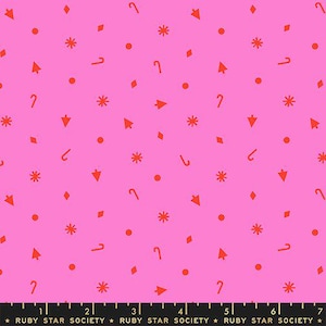 May include: Bright pink fabric with a repeating pattern of red shapes, including stars, dots, arrows, candy canes, and diamonds. The fabric has a festive, playful design, suitable for various craft projects.