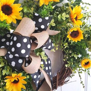Close-up of sunflowers and polka dot bow showing texture and handmade detail.
