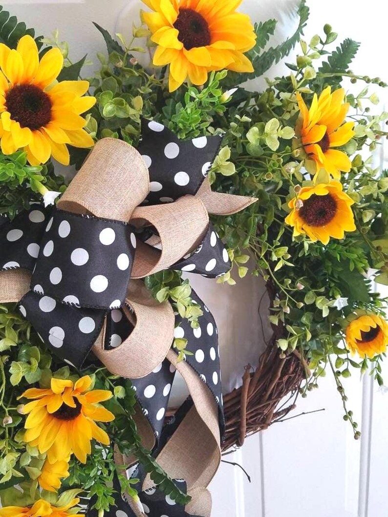 Close-up of sunflowers and polka dot bow showing texture and handmade detail.