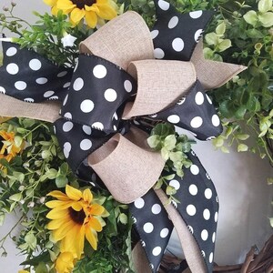 Black and white polka dot bow with natural linen ribbon on sunflower wreath.