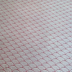 May include: A textile fabric featuring a repeating pattern of white, concentric semicircular arcs arranged in horizontal rows against a solid, muted rose-pink background. The design creates a consistent, layered wave-like visual effect across the surface.