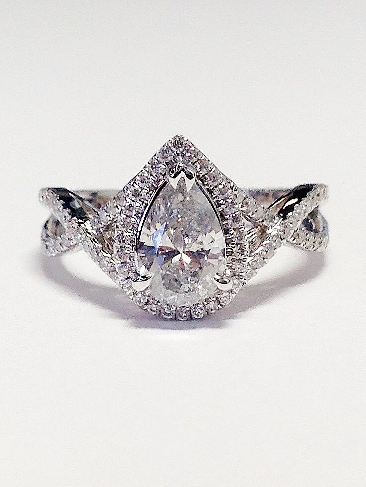 Pear shaped engagement ring with twisted band deals