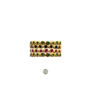 May include: Four gold rings with a row of green, blue, red, and green gemstones.