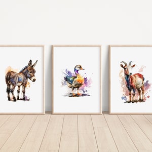 May include: Three watercolor paintings in wooden frames, each featuring a different animal. The first painting shows a brown donkey, the second shows a colorful duck, and the third shows a brown and white goat.